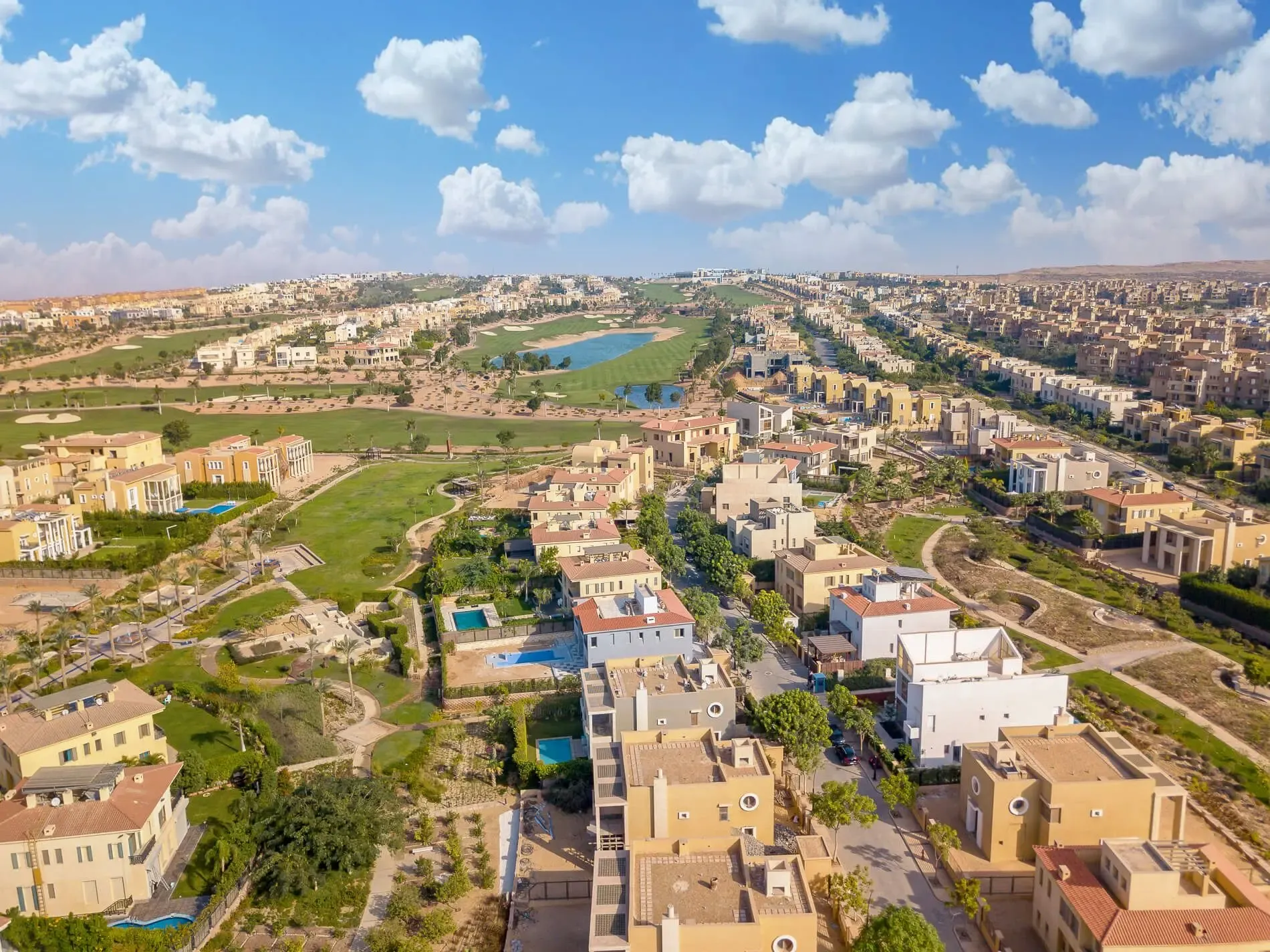Aerial view of a SODIC community, showing landscaped streets, low-rise homes and green open space